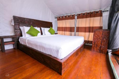 a bedroom with a large bed in a tent at Train View Chalet in Bandarawela