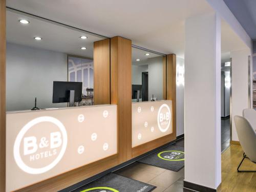 an office with a bbc hotel sign on a wall at B&B Hotel Mannheim-Neuostheim in Mannheim