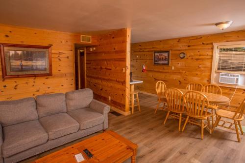 a living room with a couch and a table and chairs at HTR Black Hills Resort in Rockerville