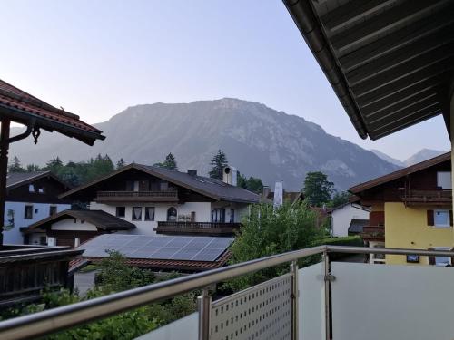 a view of a mountain with solar panels on roofs at Ferienwohnung Dahoam² inkl. Chiemgaukarte in Ruhpolding