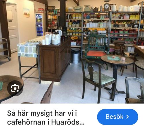 a room with tables and chairs in a store at Gunilla's house in Huaröd in Huaröd