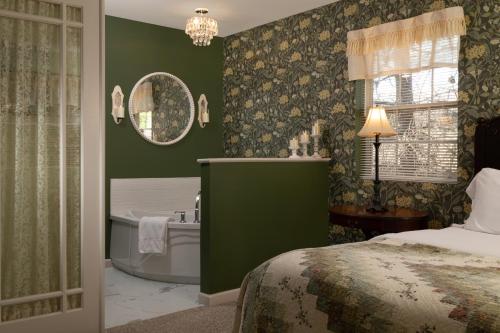 a bedroom with a bed and a bathroom with a tub at Hawk Valley Retreat & Cottages in Galena