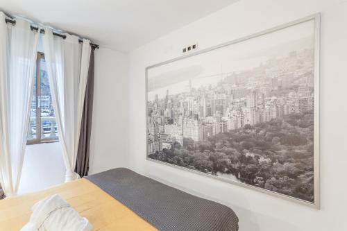a bedroom with a large window with a city view at Canarian Dream Sun and Peace in Puerto Rico de Gran Canaria