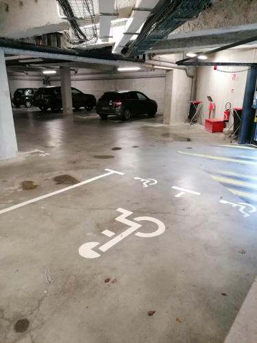 a parking garage with cars parked in it at Terres de France - Appart'Hotel Quimper Bretagne in Quimper
