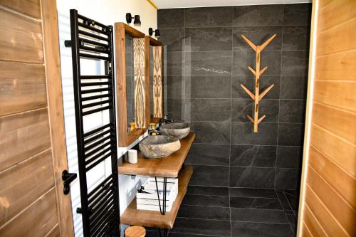 a bathroom with two sinks and a mirror at Le Chalet Margaux La Bresse in La Bresse