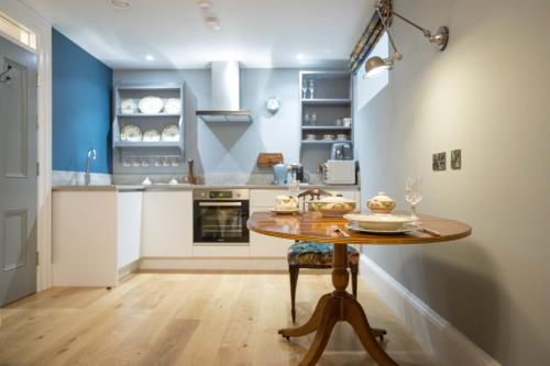 a kitchen with a wooden table in a room at Bishop's Gate Hotel in Derry Londonderry