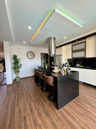 a kitchen with a large black island in a room at Valadares House in Corroios