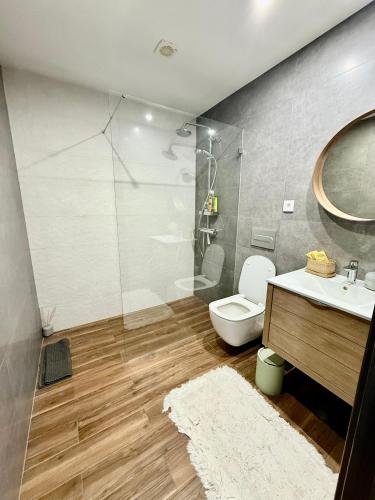 a bathroom with a toilet and a sink and a shower at Valadares House in Corroios