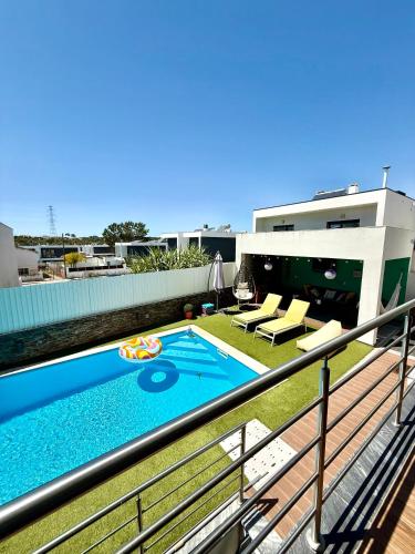 a swimming pool on the balcony of a house at Valadares House in Corroios