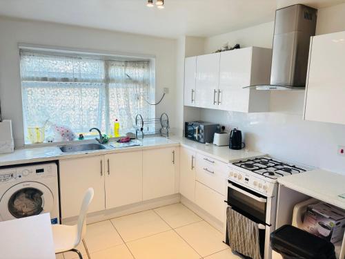 a kitchen with a sink and a stove top oven at The Bethnal Green Stay in London