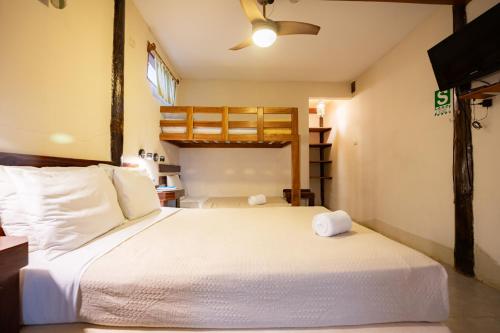 a bedroom with a large bed with two towels on it at Hospedaje La Quebrada in Máncora