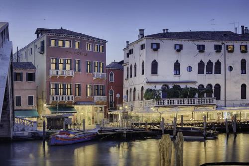 a group of buildings next to a body of water at NH Venezia Santa Lucia in Venice