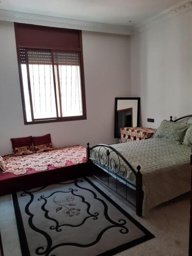 a bedroom with a bed and a window at Chambre au centre de Rabat in Rabat