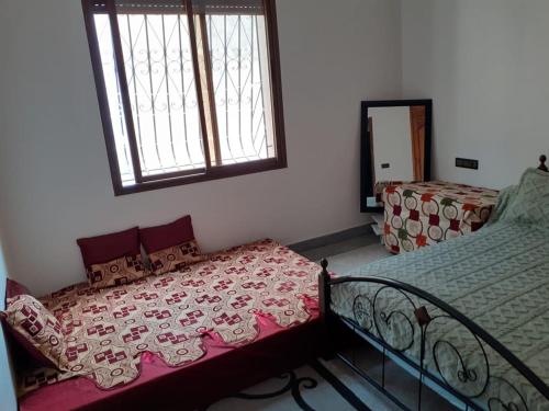a bedroom with a bed and a mirror and a window at Chambre au centre de Rabat in Rabat