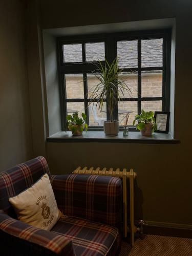a living room with a couch and a window at The Ragged Cot in Minchinhampton