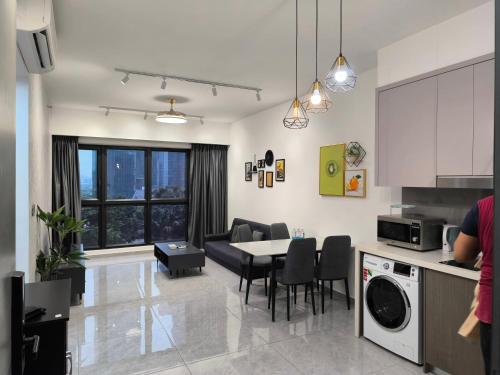 a kitchen and living room with a table and chairs at Travel Malaysia At Agile Bukit Bintang KL in Kuala Lumpur