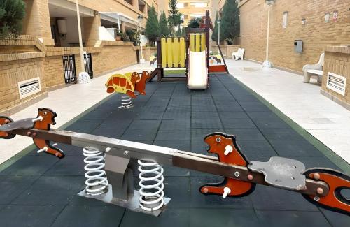 a playground in a building with a play equipment at Nasay Magic World in El Borseral