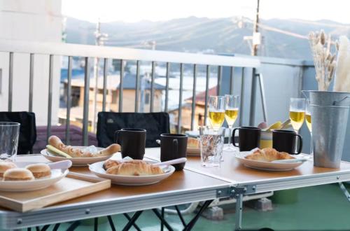 a table with plates of food and glasses of wine at Atami Ajiro no kaze - Vacation STAY 40583v in Atami