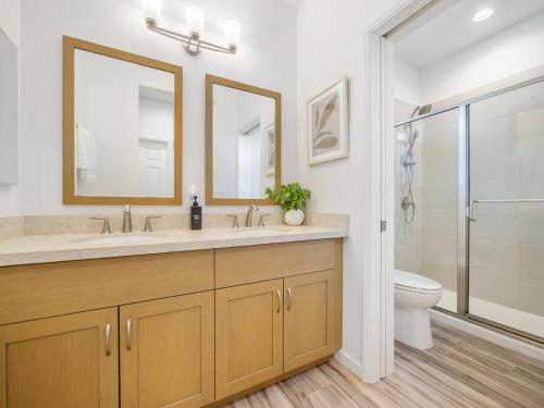 a bathroom with a sink and a toilet and a shower at Kalo Homes - Makaha Modern in Makaha Valley