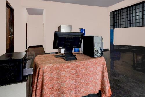 a room with a table with a computer on it at Hotel O Blue Petals in Hyderabad