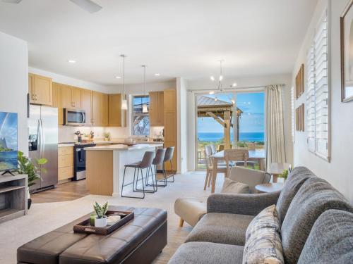 a living room with a couch and a kitchen at Breath of Life by Kalo Homes in Makaha Valley