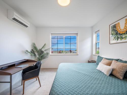 a bedroom with a desk and a bed and a desk at Makahas Hidden Gem in Makaha Valley