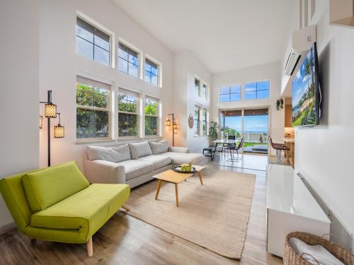 a living room with a couch and a table at Makahas Hidden Gem in Makaha Valley