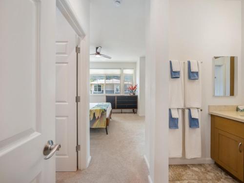 a bathroom with a door leading to a bedroom at Kalo Homes - Immersed in Aloha in Makaha Valley