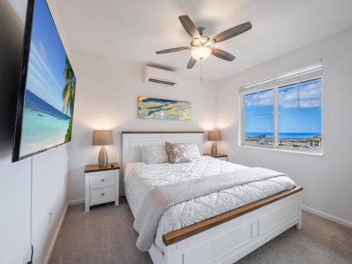 a bedroom with a bed and a ceiling fan at Kalo Homes - Makaha Mountain Hideaway in Makaha Valley