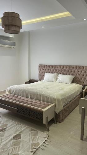 a bedroom with a large bed in a room at Modern apartment near AUC - 3BR in Cairo