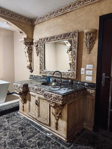 a bathroom with a sink and a mirror at Modern apartment near AUC - 3BR in Cairo