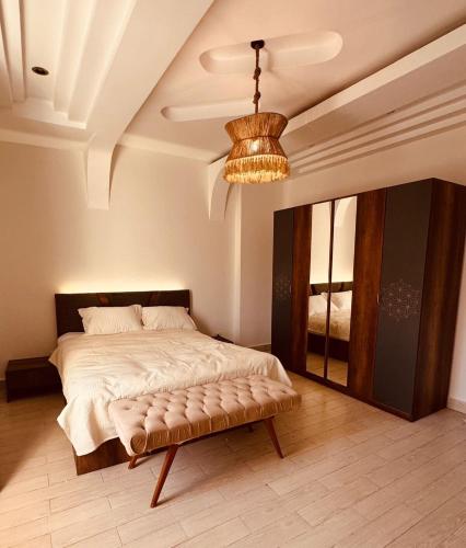 a bedroom with a large bed and a chandelier at Modern apartment near AUC - 3BR in Cairo