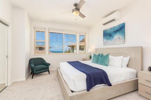 a bedroom with a large bed and a green chair at Kalo Homes Tropical Palm Getaway in Makaha Valley