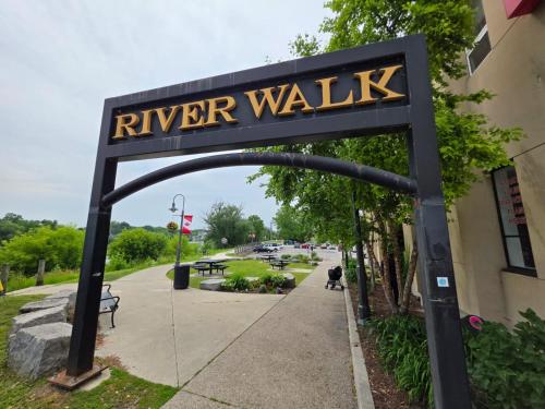 a sign for a river walk in front of a building at Modern Stylish Cozy Home Balcony Wifi in Caledonia