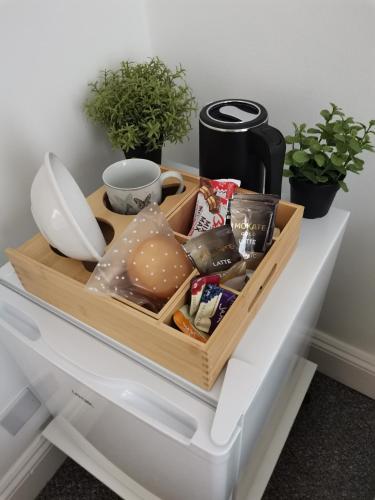 a tray of food sitting on top of an open refrigerator at Chiswick Court Hotel in London