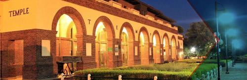 a brick building with arches on the side of it at Amazing House*relax and unwind*5 min to hospitals in Temple