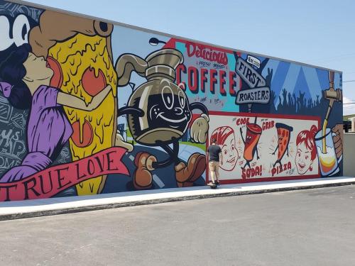 a person standing in front of a wall covered in graffiti at Amazing House*relax and unwind*5 min to hospitals in Temple