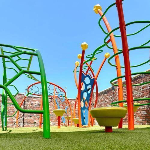 a playground with colorful equipment in a park at Amazing House*relax and unwind*5 min to hospitals in Temple
