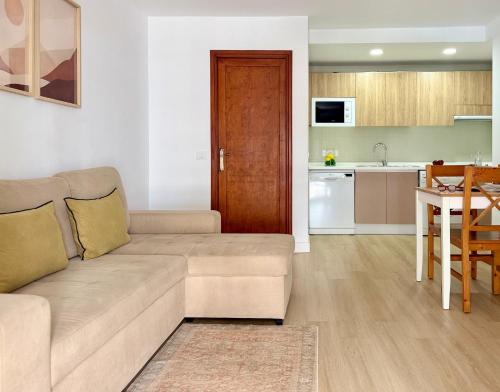 a living room with a couch and a kitchen at Canaryislandshost l Sal de Mar in Puerto del Carmen