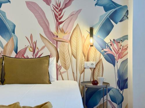 a bedroom with a mural of plants on the wall at Canaryislandshost l Sal de Mar in Puerto del Carmen