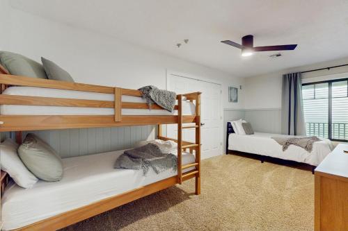 a bedroom with two bunk beds and a window at Serenity Woods Family Retreat in Glen Lord
