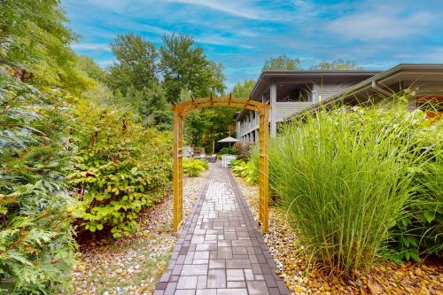 a brick walkway in the middle of a garden at Serenity Woods Family Retreat in Glen Lord