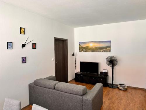 a living room with a couch and a flat screen tv at Apartmán AB kryté parkování zdarma in České Budějovice