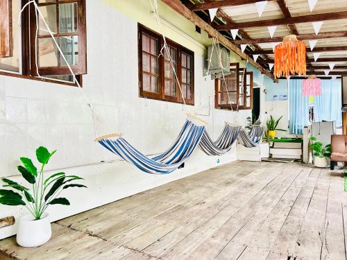 a room with two hammocks hanging from the wall at Lungkluay homestay in Ko Kood