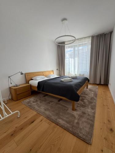a bedroom with a bed and a large window at Skau Sky Park Mint by Zaha Hadid 22 Floor 1 Tower Free Parking in Staré Mesto
