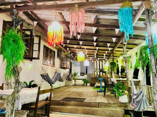 a room with tables and chairs and potted plants at Lungkluay homestay in Ko Kood
