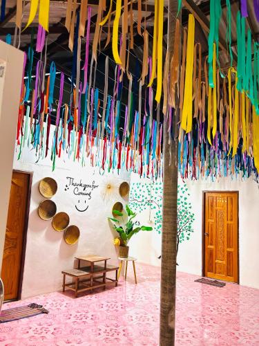 a room with colorful umbrellas hanging from the ceiling at Lungkluay homestay in Ko Kood