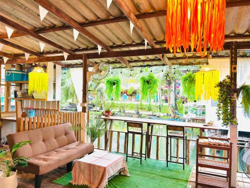 a living room with a couch and a bar at Lungkluay homestay in Ko Kood
