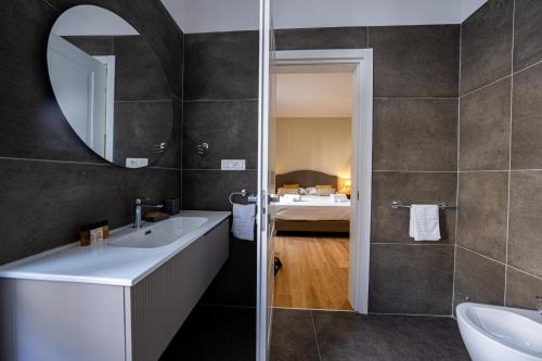 a bathroom with a sink and a mirror at MAMA Luxury in Rome