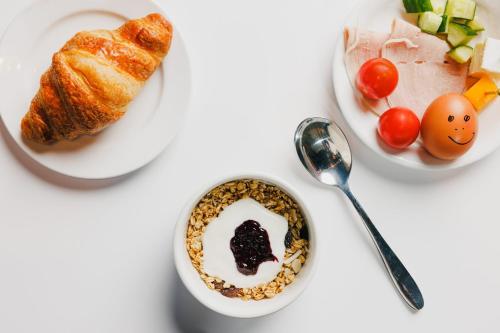 a table with a bowl of oatmeal and a plate of food at Holiday Inn Newcastle South by IHG in Boldon